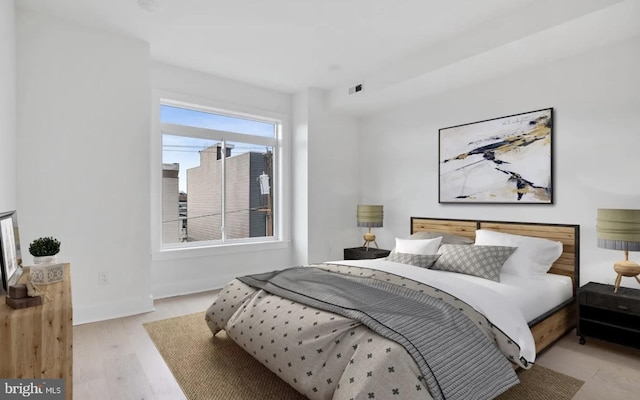 bedroom featuring baseboards and light wood-type flooring