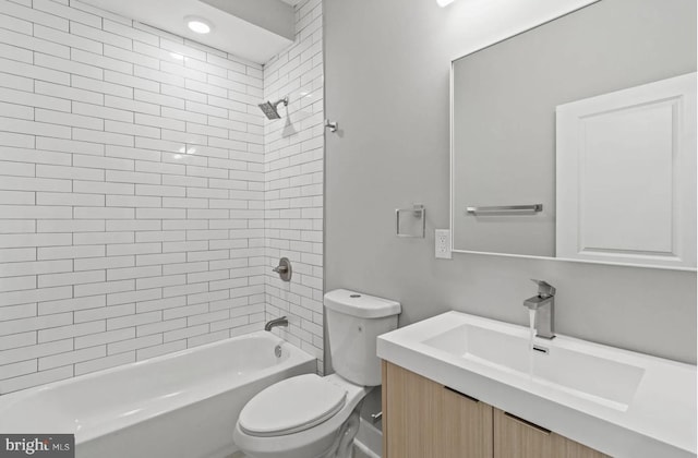 bathroom with toilet, shower / bath combination, and vanity