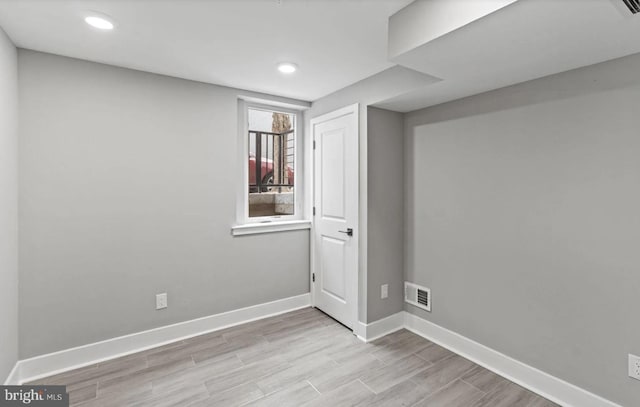 basement featuring recessed lighting, baseboards, visible vents, and wood finished floors