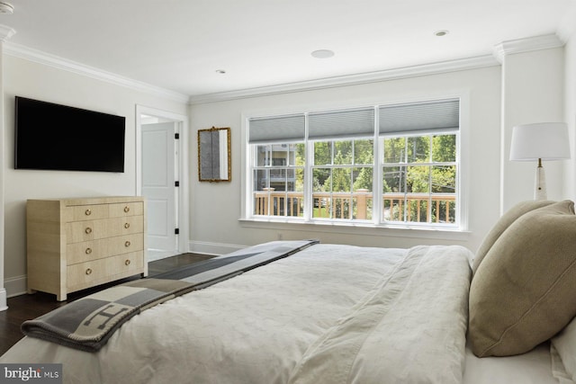 bedroom featuring baseboards, dark wood-style flooring, and crown molding