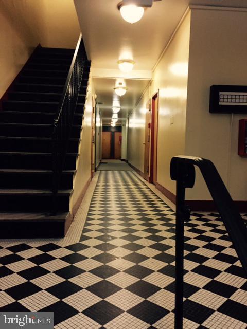 hallway featuring baseboards and stairway