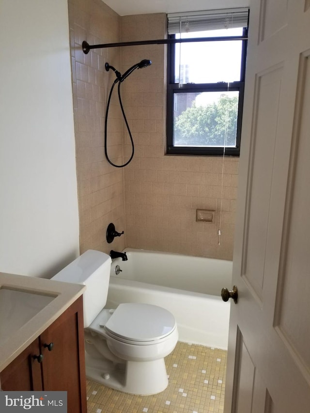 bathroom featuring toilet, tub / shower combination, tile patterned flooring, and vanity