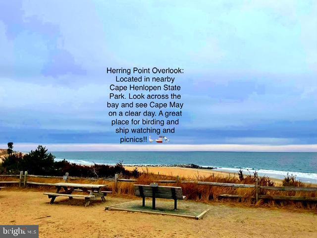 view of property's community featuring a beach view and a water view