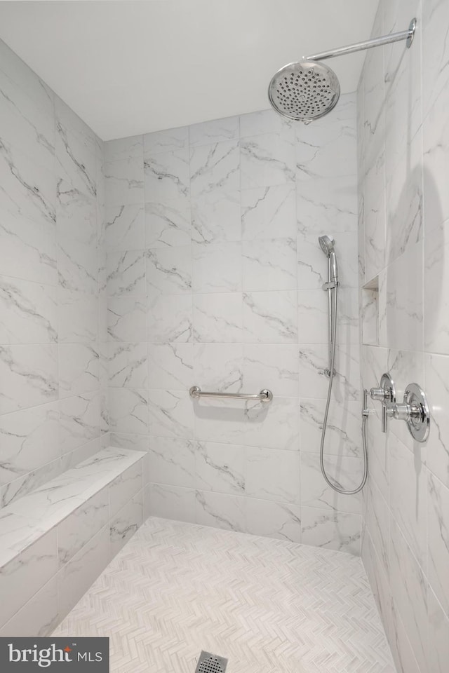full bath featuring a tile shower