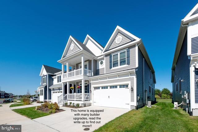 view of front of home with driveway, central AC, a balcony, a front lawn, and an attached garage