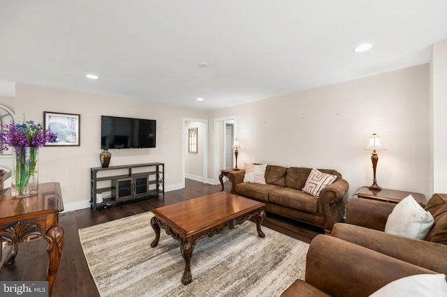 living room with dark wood-style flooring, baseboards, and recessed lighting