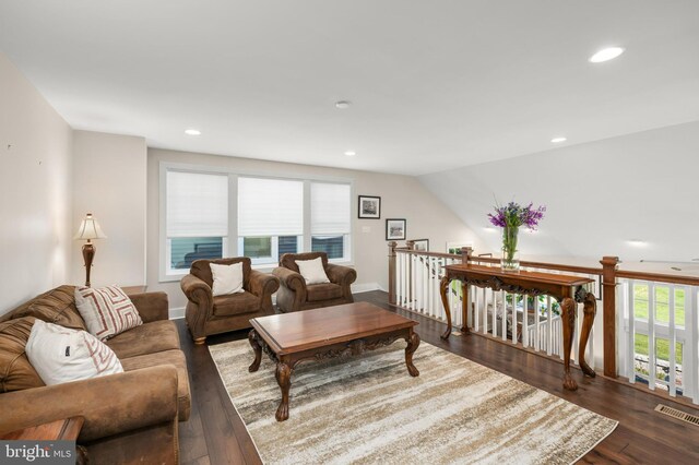 living room with visible vents, recessed lighting, and wood finished floors