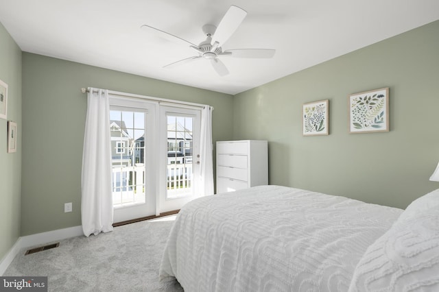 carpeted bedroom with baseboards, access to outside, ceiling fan, and visible vents