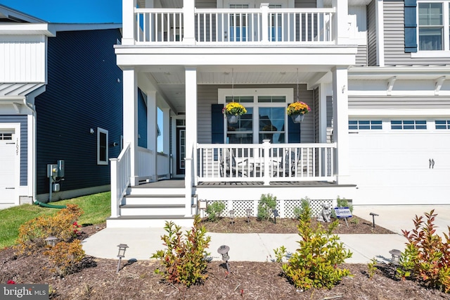 entrance to property with covered porch, an attached garage, and a balcony