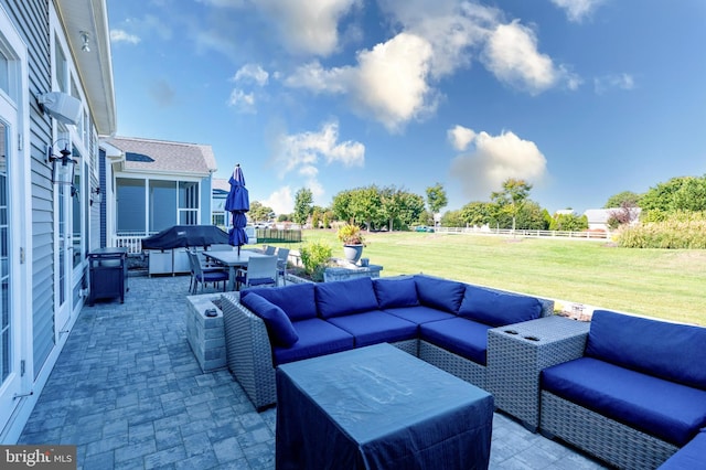 view of patio with an outdoor living space, fence, and outdoor dining space