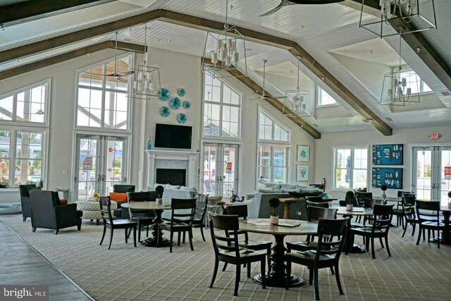 carpeted dining space featuring french doors, a chandelier, high vaulted ceiling, and beamed ceiling