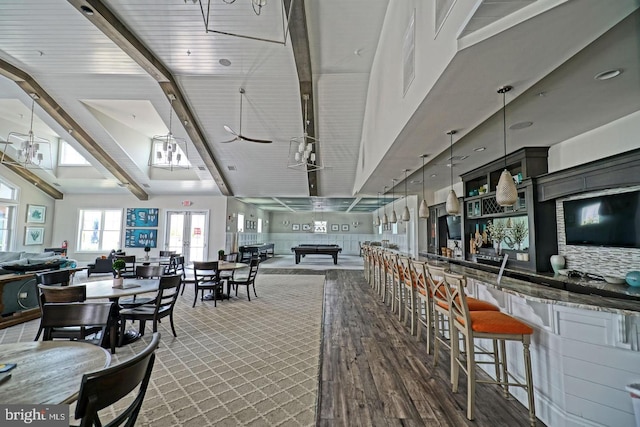 bar featuring beamed ceiling, hanging light fixtures, billiards, and high vaulted ceiling