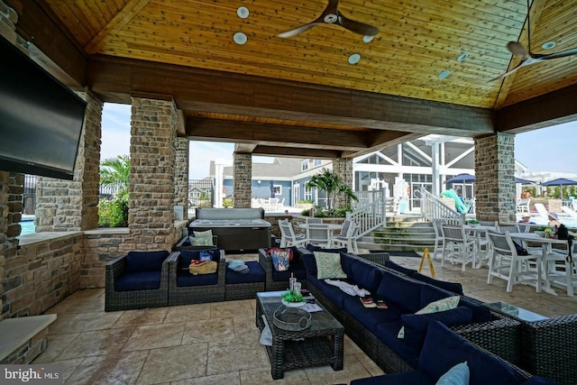 view of patio / terrace featuring area for grilling, outdoor dining area, a ceiling fan, and an outdoor hangout area