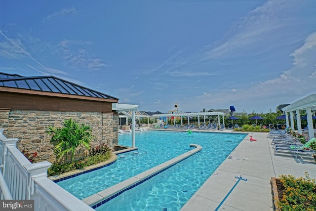 community pool with a pergola