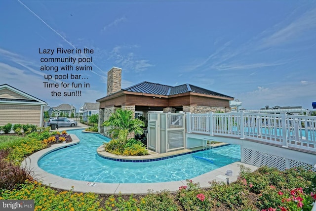 view of swimming pool featuring a deck