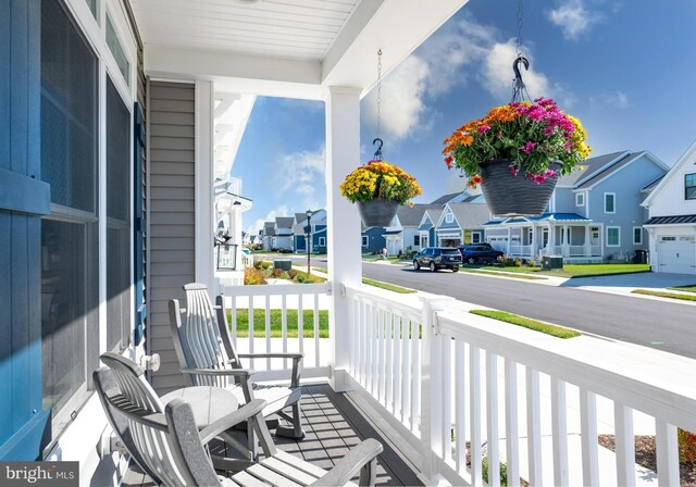 balcony with covered porch and a residential view