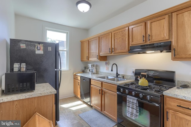 kitchen with a sink, dishwasher, light countertops, black range with gas cooktop, and under cabinet range hood