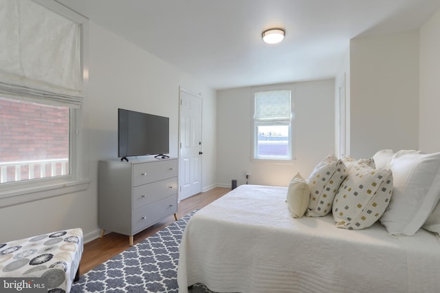 bedroom featuring baseboards and wood finished floors