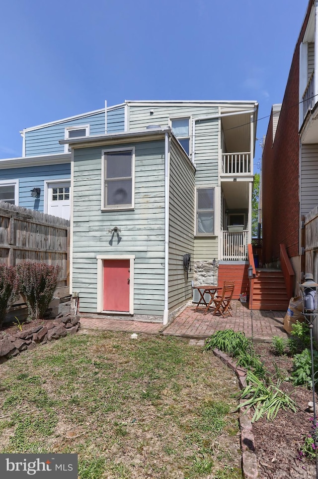 back of property with a patio and fence
