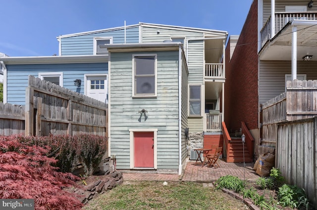 back of house with fence