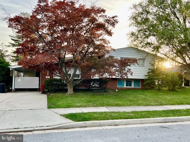 view of front of home with driveway and a front lawn