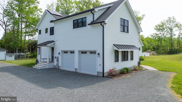 32991 Daisey Rd, Frankford, DE 19945 - view of front of house with a front yard, a garage, an outdoor structure, aphalt driveway, and a shingled roof