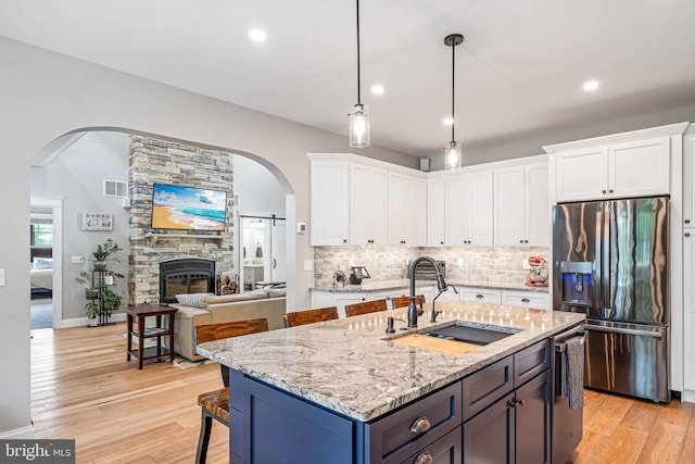 32991 Daisey Rd, Frankford, DE 19945 - kitchen with stainless steel fridge, a sink, white cabinetry, and visible vents