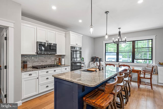 32991 Daisey Rd, Frankford, DE 19945 - kitchen with a sink, white cabinets, light wood finished floors, stainless steel appliances, and recessed lighting