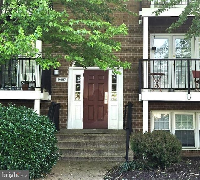 entrance to property with brick siding