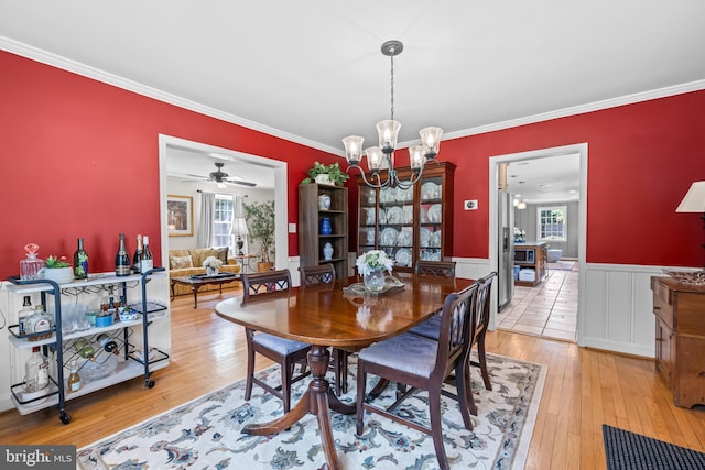 2430 Stanwick Rd, Phoenix, MD 21131 - dining space with light wood-style floors, ornamental molding, wainscoting, and ceiling fan with notable chandelier