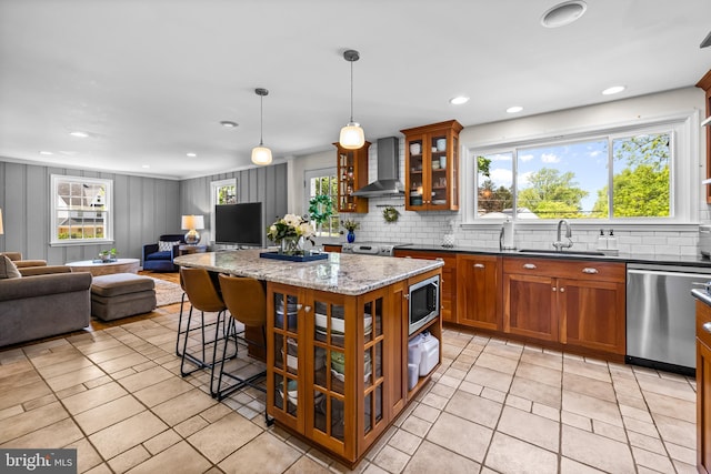 2430 Stanwick Rd, Phoenix, MD 21131 - kitchen with brown cabinetry, decorative backsplash, open floor plan, wall chimney exhaust hood, and stainless steel appliances