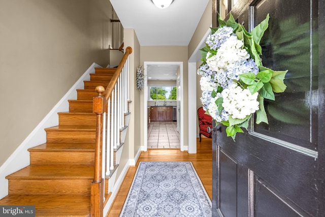 2430 Stanwick Rd, Phoenix, MD 21131 - foyer entrance with baseboards, stairs, and light wood finished floors