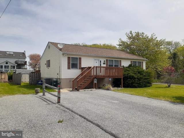 single story home featuring a storage shed, an outbuilding, and a front yard