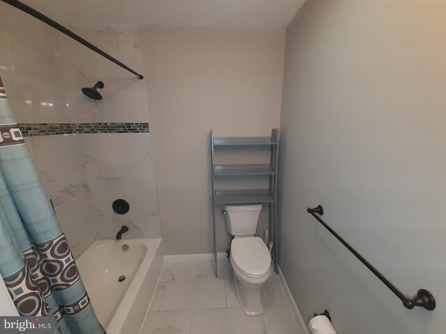 bathroom with baseboards, shower / bath combo, toilet, and marble finish floor
