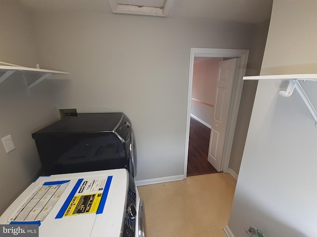 laundry room featuring independent washer and dryer, laundry area, baseboards, and attic access