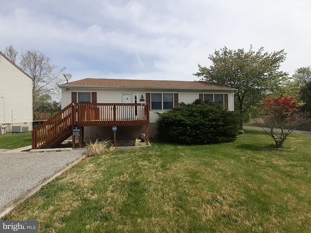 back of property with a lawn, central AC, a deck, and stairway