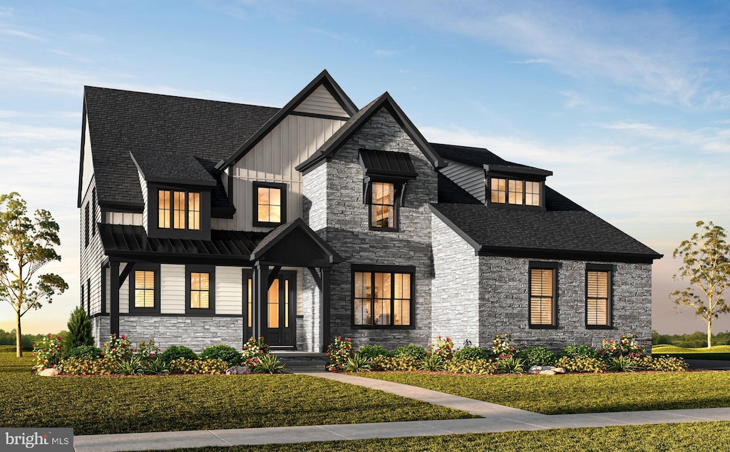 modern inspired farmhouse with a lawn, board and batten siding, and stone siding