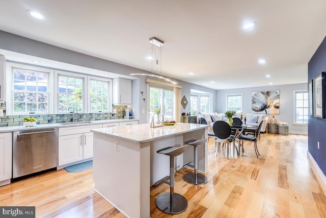 20662 Ashleaf Ct, Sterling, VA 20165 - kitchen with stainless steel dishwasher, open floor plan, a sink, a kitchen island, and recessed lighting