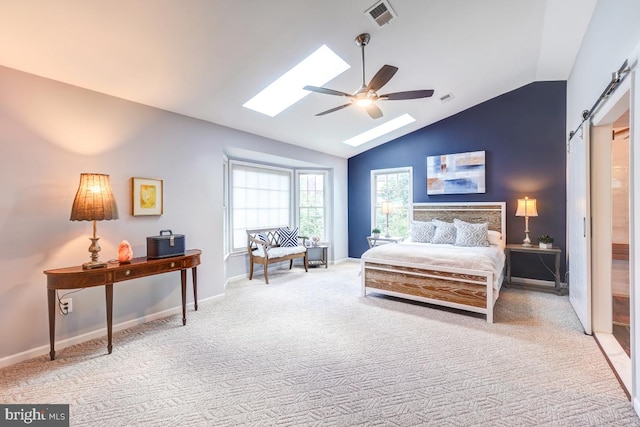 20662 Ashleaf Ct, Sterling, VA 20165 - carpeted bedroom featuring vaulted ceiling, a barn door, a skylight, baseboards, and a ceiling fan