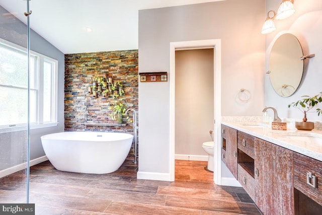 20662 Ashleaf Ct, Sterling, VA 20165 - full bathroom featuring toilet, double vanity, a freestanding bath, and baseboards