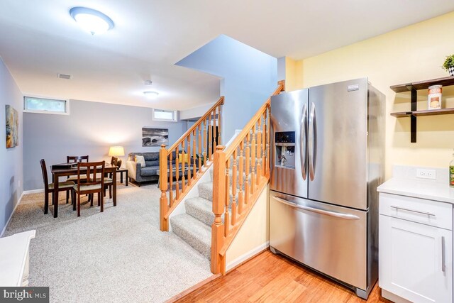 20662 Ashleaf Ct, Sterling, VA 20165 - kitchen featuring stainless steel refrigerator with ice dispenser, white cabinetry, and light countertops