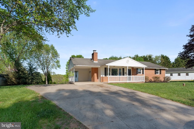 view of front of house featuring covered porch, driveway, a chimney, brick siding, and a front lawn