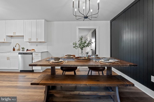 dining area featuring light wood-type flooring and a notable chandelier