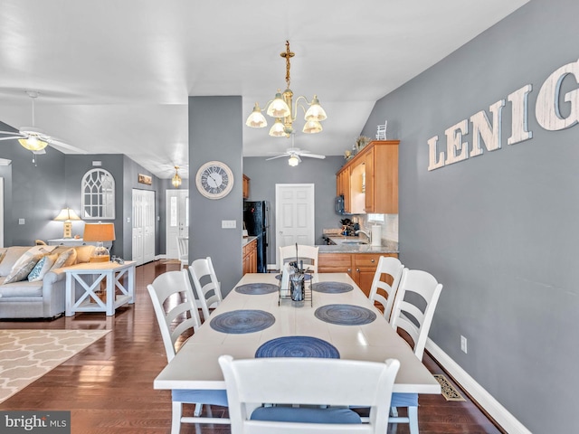 10350 Keyser Point Rd, Ocean City, MD 21842 - dining space featuring a ceiling fan, dark wood-type flooring, vaulted ceiling, a chandelier, and baseboards