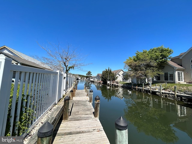 dock area featuring a residential view and a water view
