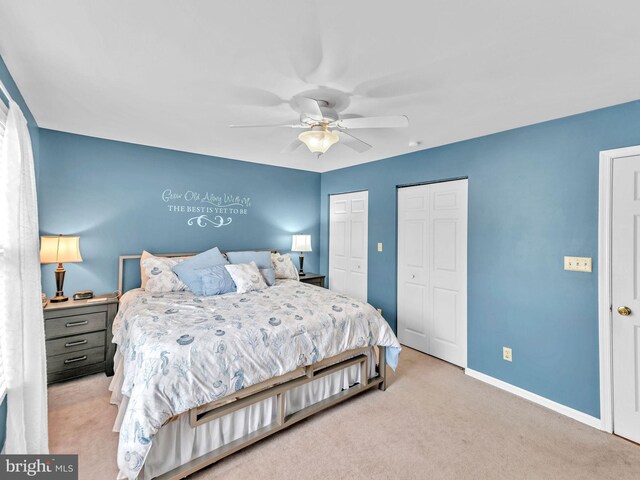 10350 Keyser Point Rd, Ocean City, MD 21842 - bedroom with two closets, light carpet, baseboards, and ceiling fan