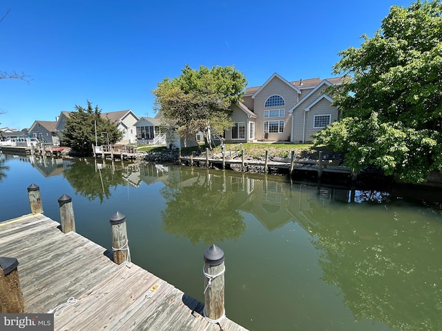 view of dock with a water view and a residential view