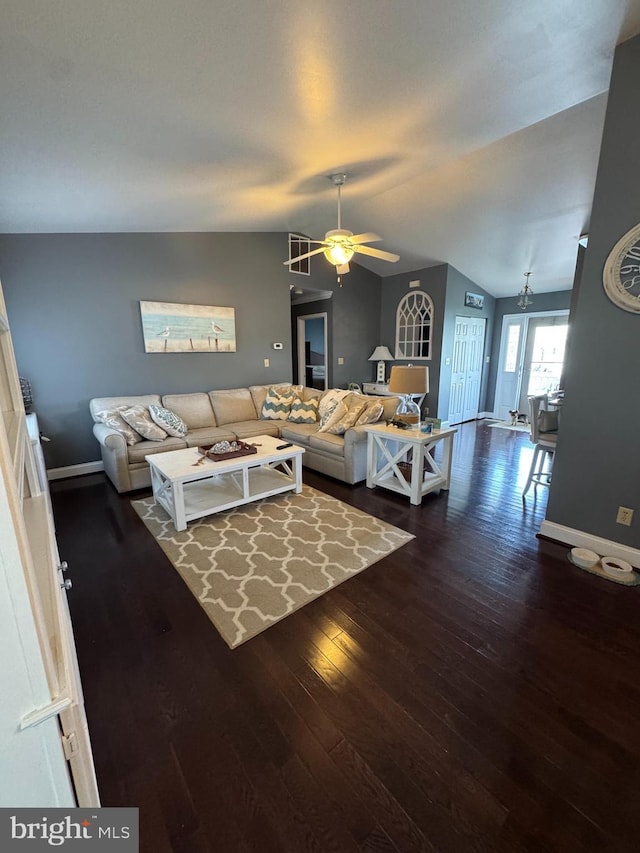 living area with baseboards, ceiling fan, vaulted ceiling, and hardwood / wood-style flooring