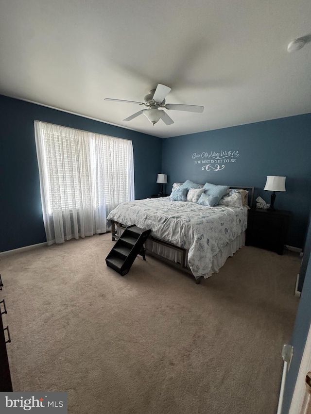 bedroom featuring ceiling fan and light carpet