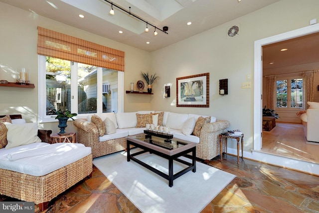 living area with track lighting, recessed lighting, and visible vents
